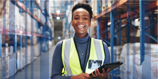 warehouse worker smiling with a tablet