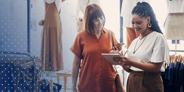 Small business owner talking to customer while holidng a tablet 