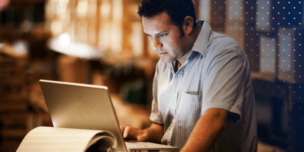 Warehouse manager looking at computer